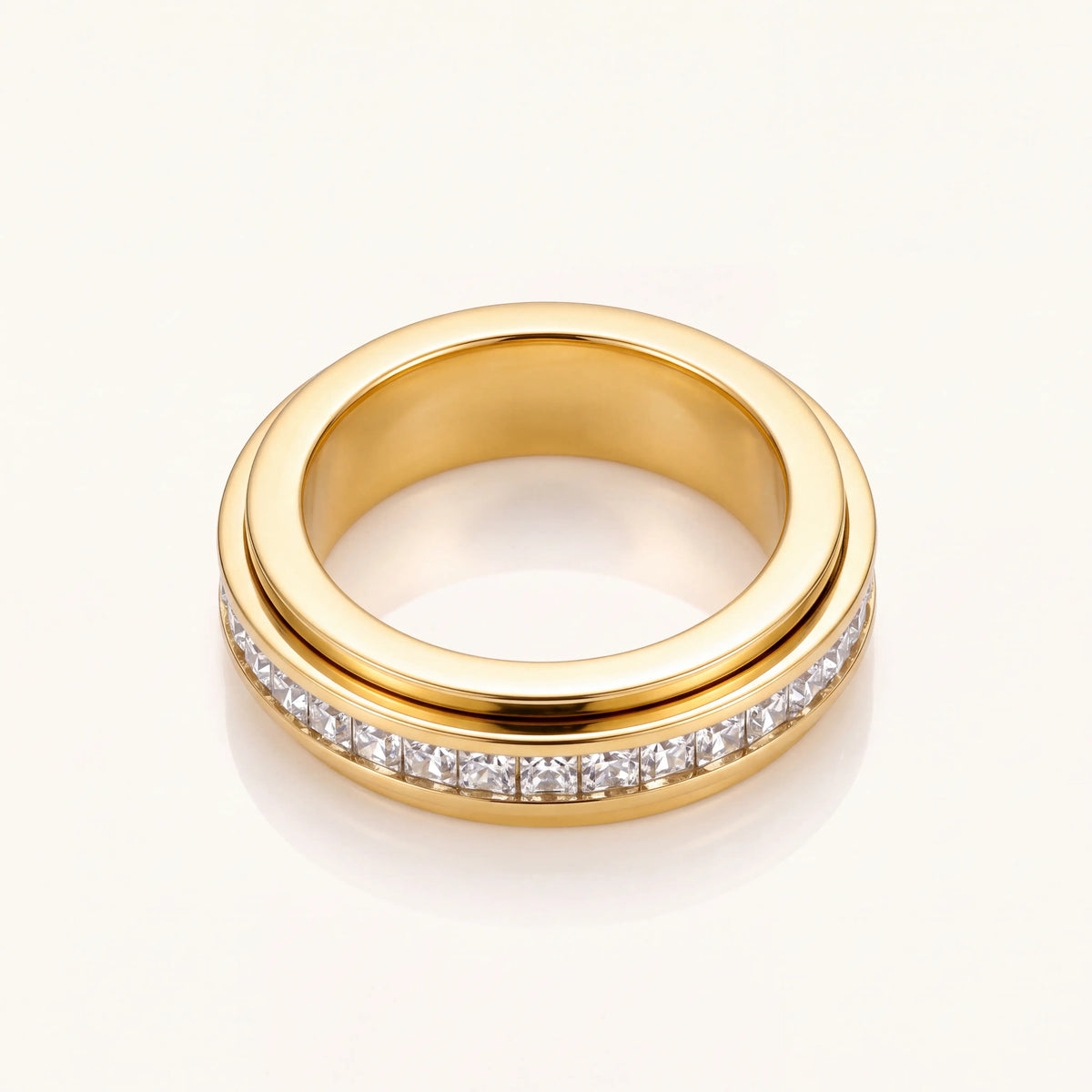 Gold stone-set band ring tilted to show band width and stone row