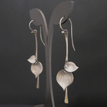 Load image into Gallery viewer, Elegant Vintage Drop Earrings in Silver pair of silver leaf-shaped earrings displayed on a dark background.
