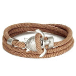 Load image into Gallery viewer, Elegant Sea Turtle Bracelet beige braided bracelet with silver anchor charm displayed on a white background.
