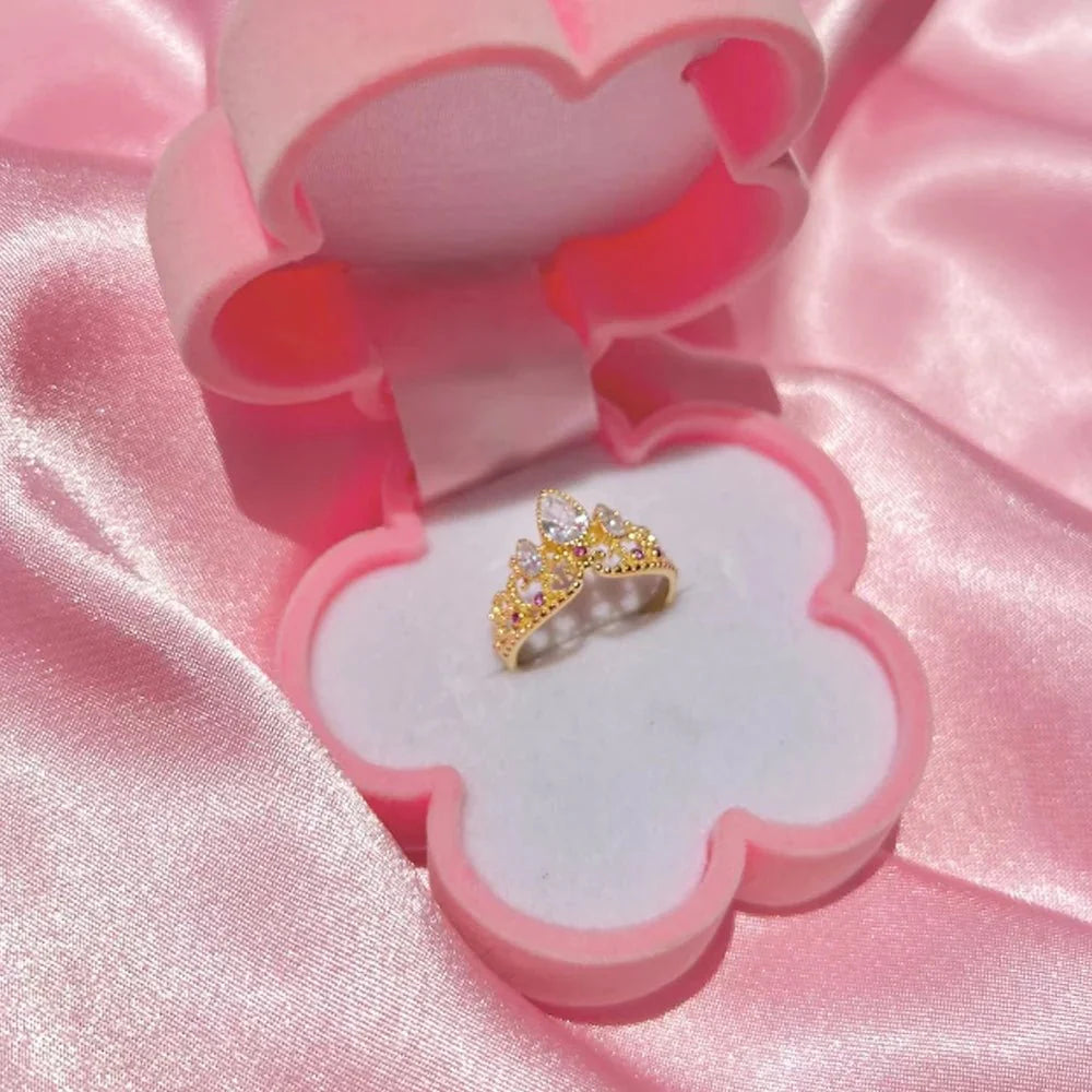Rapunzel Crown Inspired Necklaces and Rings gold ring displayed in a pink heart-shaped jewelry box on a pink satin background.