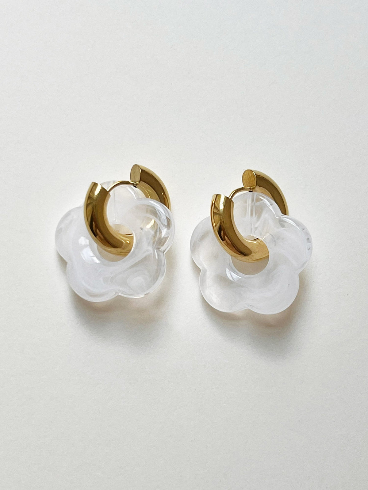 White donut hoop earrings with flower charm